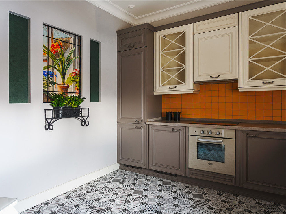 Inspiration for a traditional kitchen in Moscow with orange splashback.