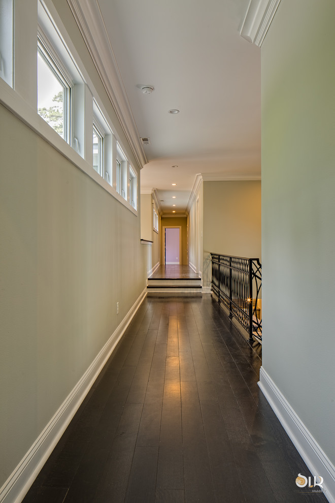Mid-sized transitional dark wood floor and brown floor hallway photo with beige walls