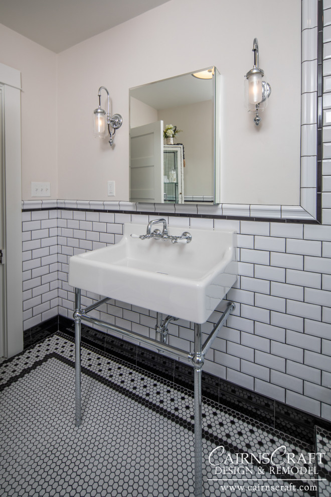 Photo of a small traditional shower room bathroom in San Diego with a walk-in shower, a two-piece toilet, black and white tiles, metro tiles, white walls, mosaic tile flooring, a wall-mounted sink, white floors, an open shower, a wall niche, a single sink and wainscoting.