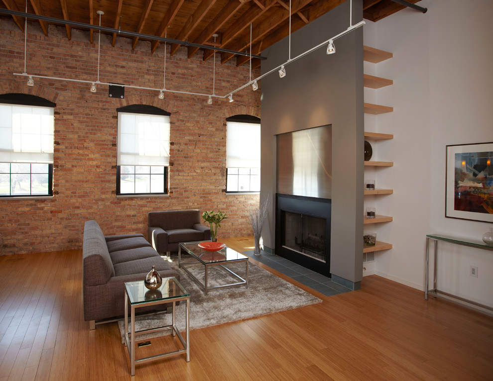 Design ideas for an industrial formal living room in Chicago with grey walls, bamboo floors, a standard fireplace and a metal fireplace surround.