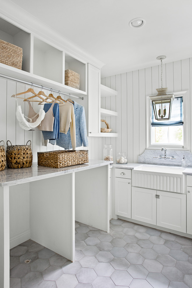 Inspiration for a huge transitional gray floor dedicated laundry room remodel in Dallas with a farmhouse sink, shaker cabinets, white backsplash, shiplap backsplash, white walls, a side-by-side washer/dryer and gray countertops