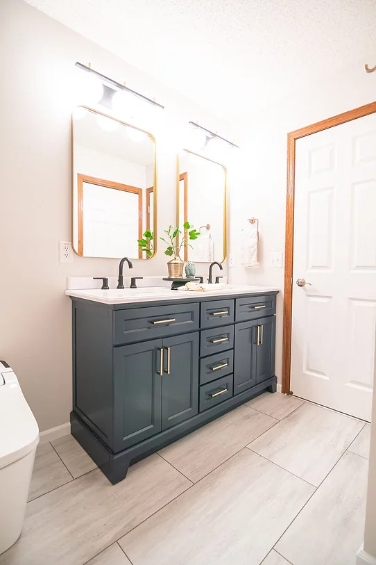 Photo of a small transitional master bathroom in Minneapolis with shaker cabinets, blue cabinets, an alcove tub, a shower/bathtub combo, a bidet, white tile, ceramic tile, white walls, an undermount sink, engineered quartz benchtops, beige floor, a shower curtain, white benchtops, a double vanity and a freestanding vanity.