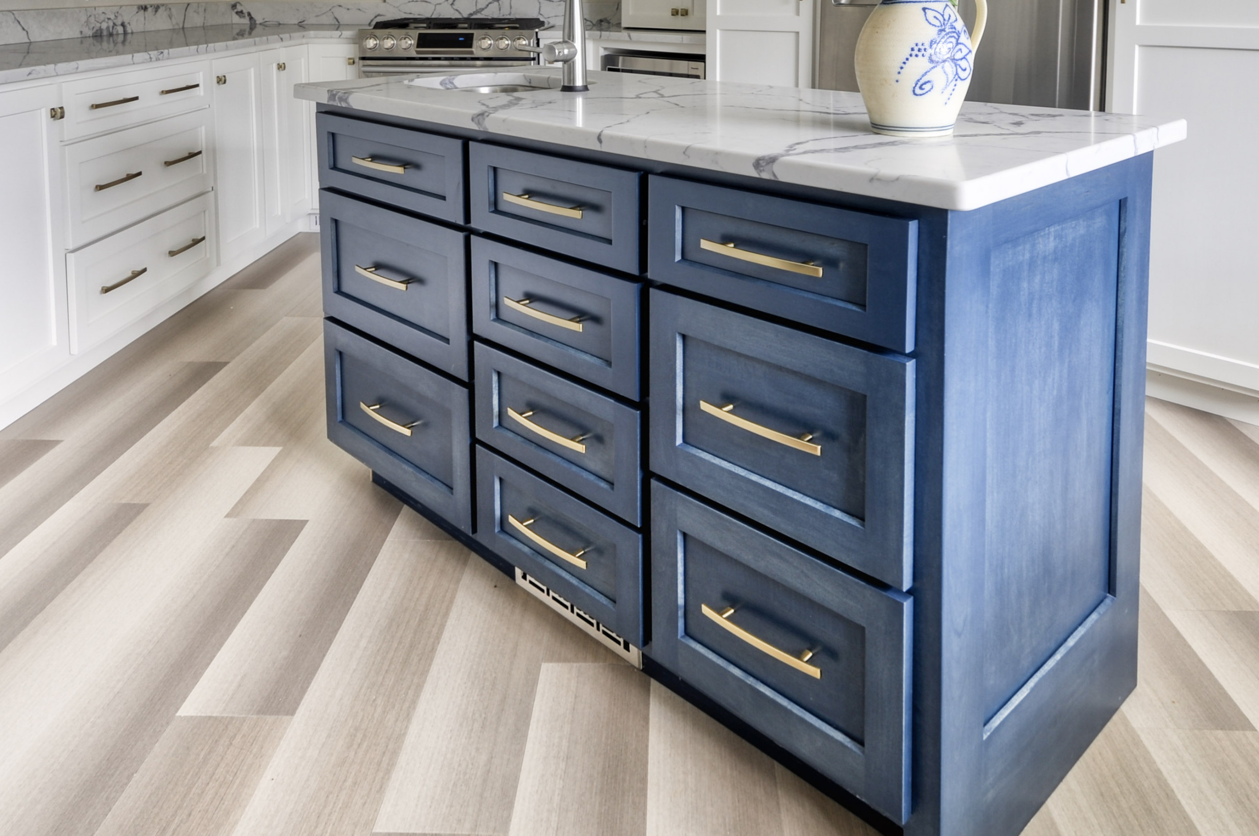 Navy Stained Island, Hood vent and Floating Shelves in White Shaker Kitchen