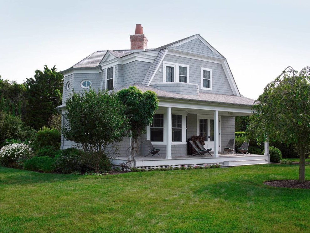 Design ideas for a small traditional two-storey exterior in New York with wood siding and a gambrel roof.