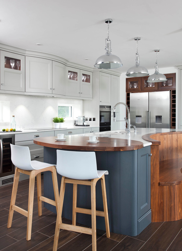 Transitional open plan kitchen in Other with a drop-in sink, grey cabinets, with island and brown floor.
