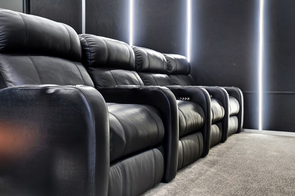 Design ideas for a mid-sized contemporary enclosed home theatre in Miami with black walls, carpet, a projector screen and grey floor.