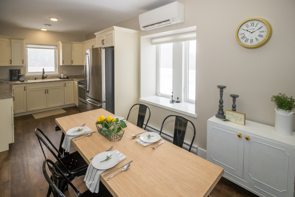 Mid-sized u-shaped vinyl floor and brown floor kitchen photo with a drop-in sink, recessed-panel cabinets, yellow cabinets, laminate countertops, stainless steel appliances, no island and brown countertops