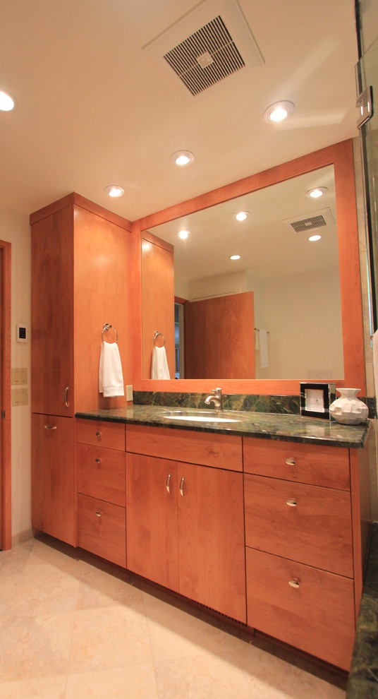 This is an example of a mid-sized contemporary kids bathroom in Other with flat-panel cabinets, medium wood cabinets, a drop-in tub, an open shower, a wall-mount toilet, brown tile, porcelain tile, white walls, porcelain floors, an undermount sink, granite benchtops, grey floor and a hinged shower door.