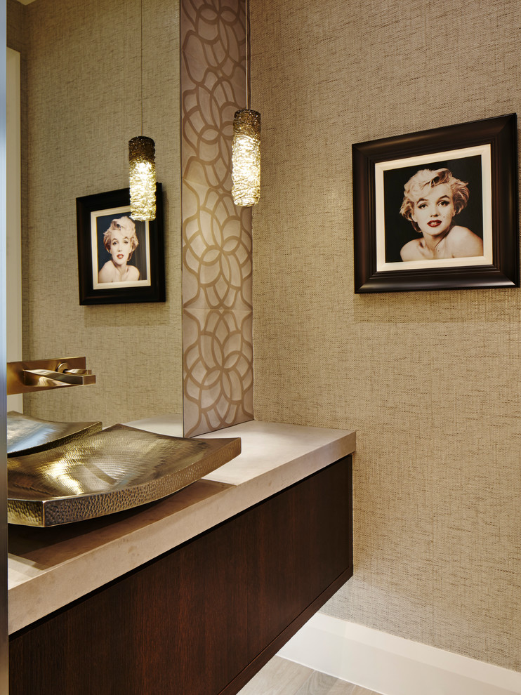 Photo of a contemporary powder room in Miami with flat-panel cabinets, dark wood cabinets, beige walls and a vessel sink.