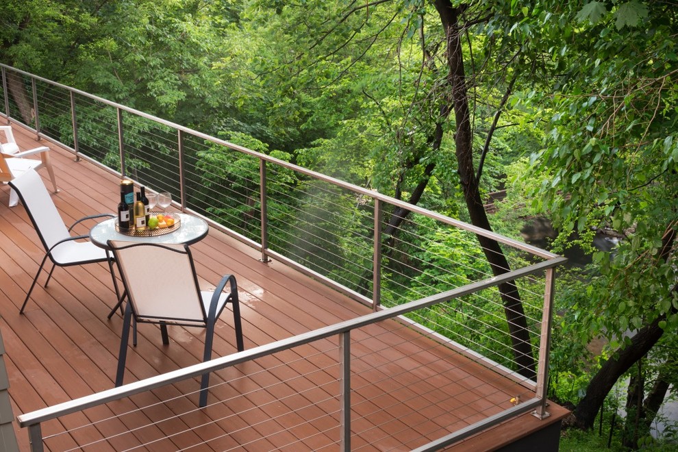 This is an example of an expansive modern backyard deck in Minneapolis with no cover.