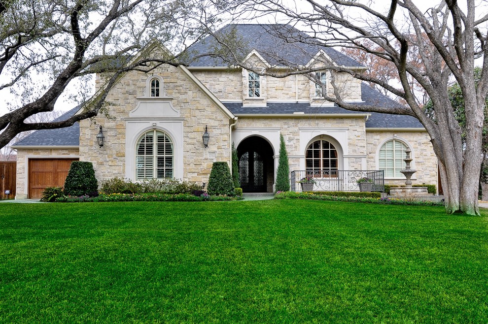 Inspiration for an expansive traditional one-storey exterior in Dallas with stone veneer.