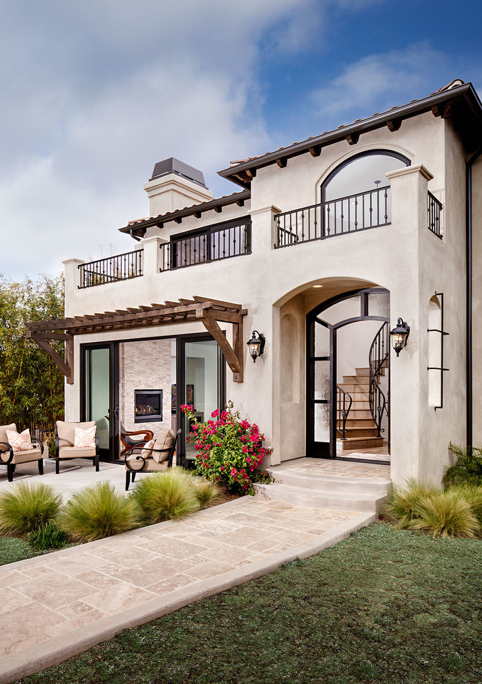 Inspiration for an expansive mediterranean stucco beige exterior in San Diego.