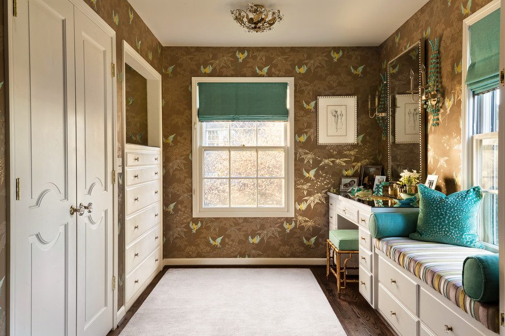 This is an example of a mid-sized transitional women's dressing room in Portland with white cabinets, raised-panel cabinets and dark hardwood floors.