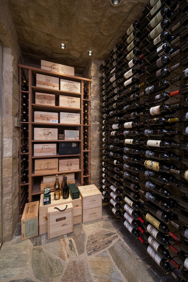 Inspiration for a mid-sized transitional wine cellar in Phoenix with limestone floors and storage racks.