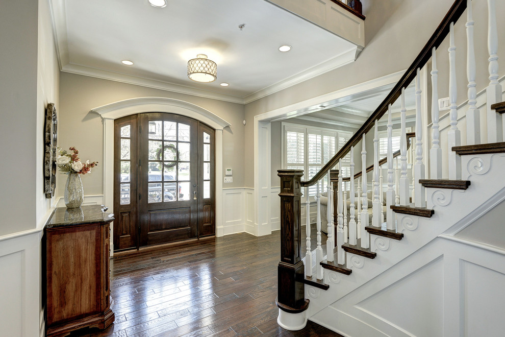 Design ideas for a large traditional foyer in DC Metro with grey walls, medium hardwood floors, a single front door and a dark wood front door.