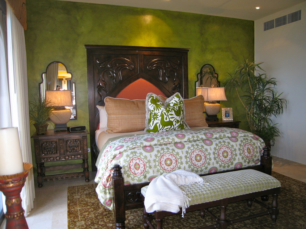 Design ideas for a large mediterranean master bedroom in Mexico City with green walls, travertine floors and no fireplace.