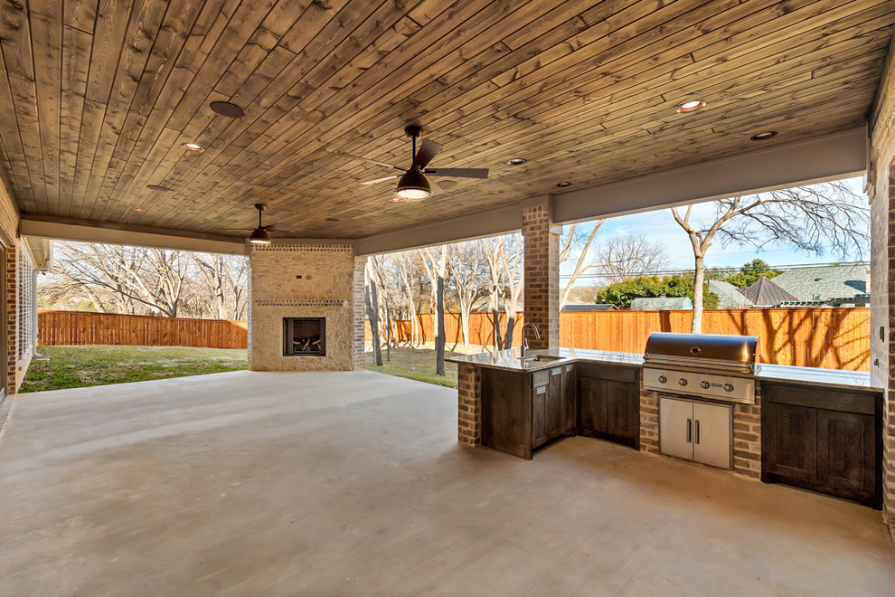Design ideas for an expansive transitional backyard verandah in Dallas with an outdoor kitchen and a roof extension.