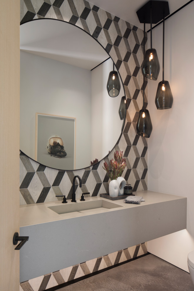 Inspiration for a rustic black and white tile concrete floor, gray floor, single-sink and vaulted ceiling powder room remodel with white walls, a drop-in sink, solid surface countertops, gray countertops and a floating vanity