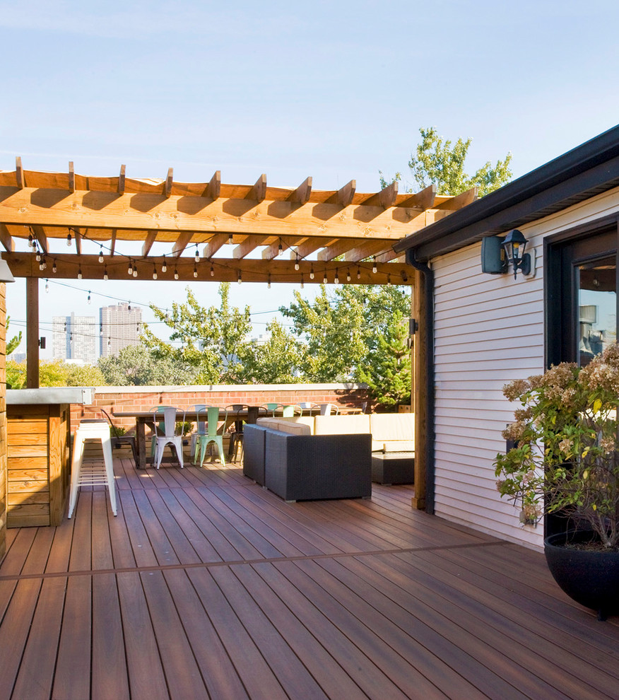 This is an example of an expansive eclectic rooftop deck in Baltimore with a pergola.