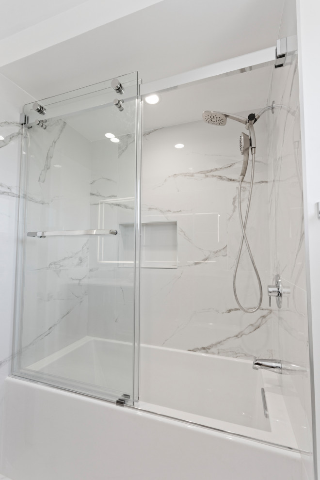 Design ideas for a medium sized modern shower room bathroom in San Francisco with flat-panel cabinets, brown cabinets, a built-in bath, a shower/bath combination, a one-piece toilet, grey tiles, marble tiles, white walls, marble flooring, a submerged sink, marble worktops, grey floors, a sliding door, grey worktops and double sinks.
