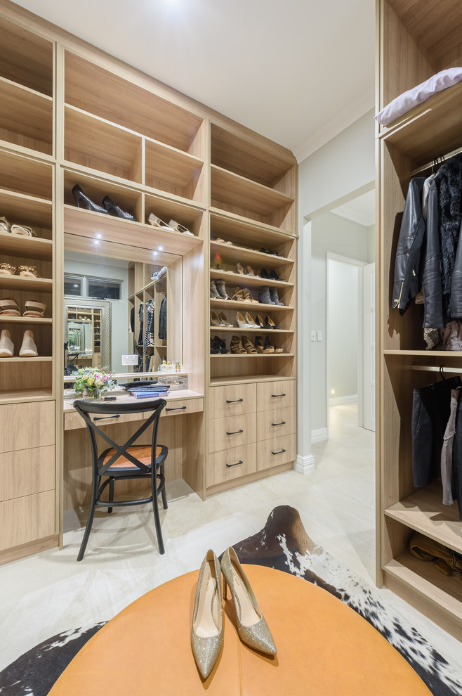 Photo of a large transitional gender-neutral dressing room in Perth with flat-panel cabinets, light wood cabinets, porcelain floors and beige floor.