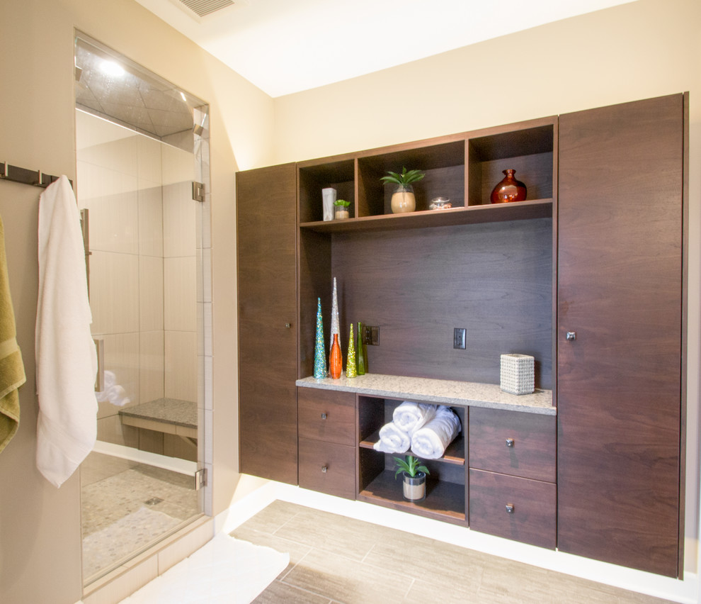 This is an example of a contemporary master bathroom in Cedar Rapids with an alcove shower, beige walls, porcelain floors, brown floor and a hinged shower door.