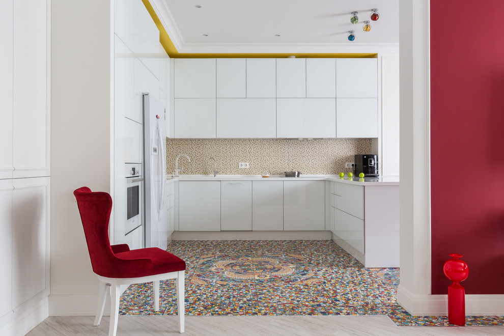 Inspiration for a contemporary u-shaped kitchen in Other with flat-panel cabinets, white cabinets, white appliances, a peninsula, multi-coloured floor, white benchtop and multi-coloured splashback.