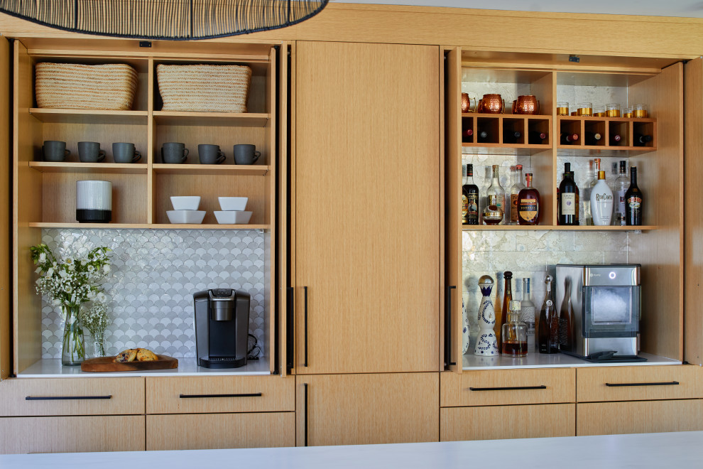 Mid-sized contemporary single-wall home bar in New York with no sink, flat-panel cabinets, medium wood cabinets, quartz benchtops, multi-coloured splashback, mosaic tile splashback and white benchtop.