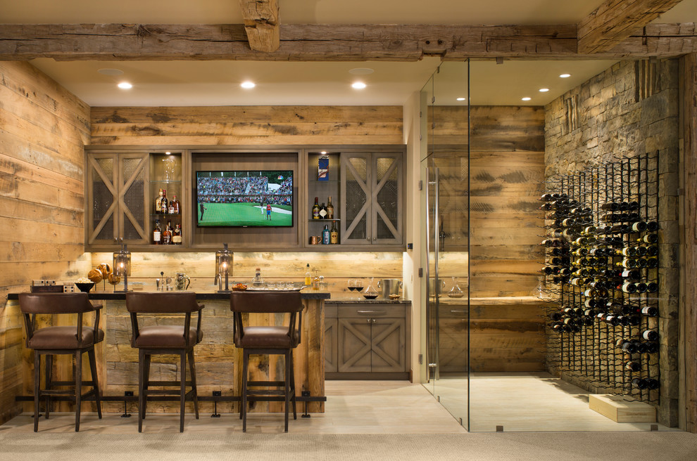 Photo of a mid-sized country galley seated home bar in Denver with shaker cabinets, distressed cabinets, brown splashback, timber splashback, light hardwood floors and brown floor.