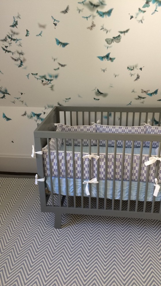 Photo of a mid-sized transitional gender-neutral nursery in San Francisco with blue walls, carpet and beige floor.
