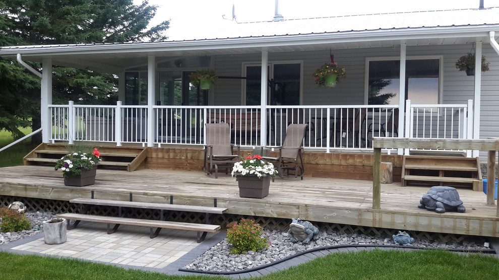 Backyard deck photo in Edmonton with a roof extension