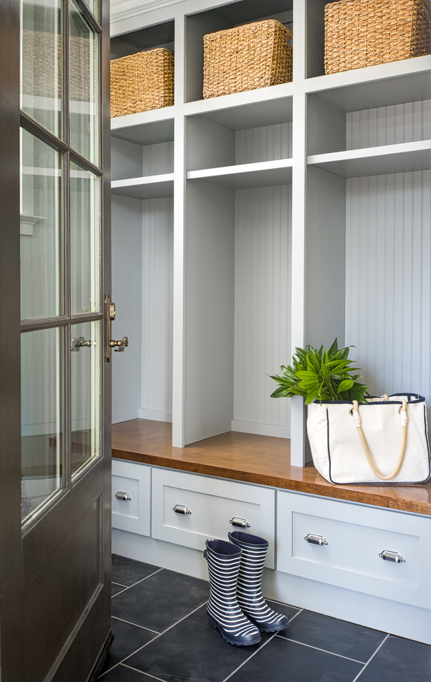 Mid-sized transitional slate floor and black floor mudroom photo in Atlanta with shaker cabinets, wood countertops, gray walls and a black front door
