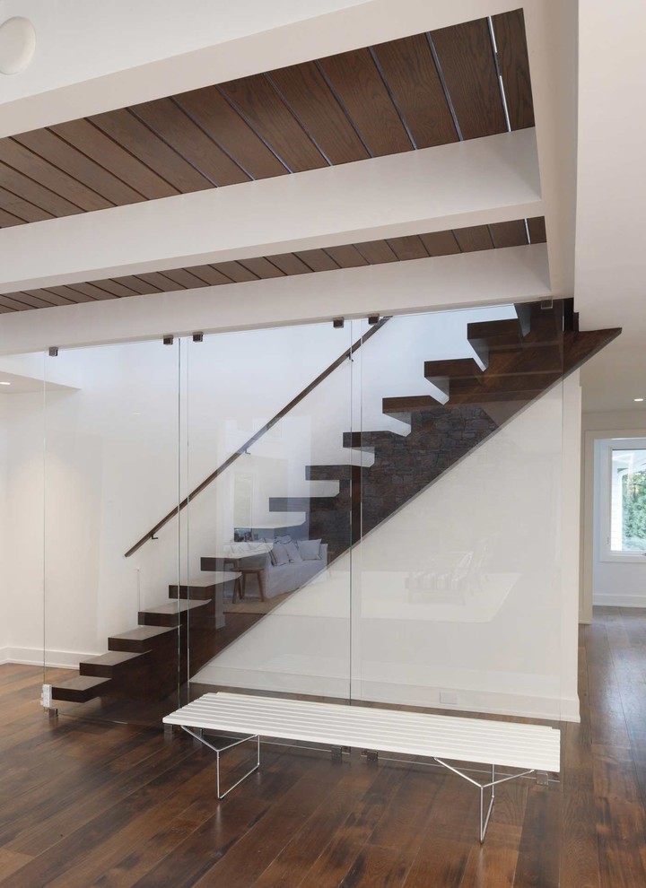 Contemporary wood straight staircase in New York with open risers.