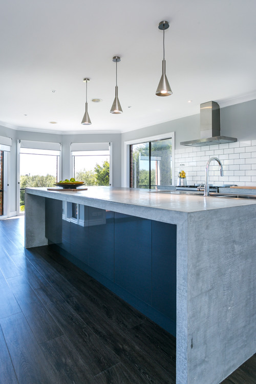 Inspiration for an expansive contemporary galley eat-in kitchen in Melbourne with a double-bowl sink, open cabinets, white cabinets, concrete benchtops, white splashback, subway tile splashback, stainless steel appliances and with island.