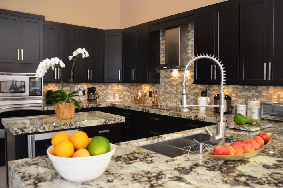 Large transitional u-shaped porcelain tile open concept kitchen photo in Miami with an undermount sink, shaker cabinets, dark wood cabinets, granite countertops, multicolored backsplash, mosaic tile backsplash, stainless steel appliances and an island
