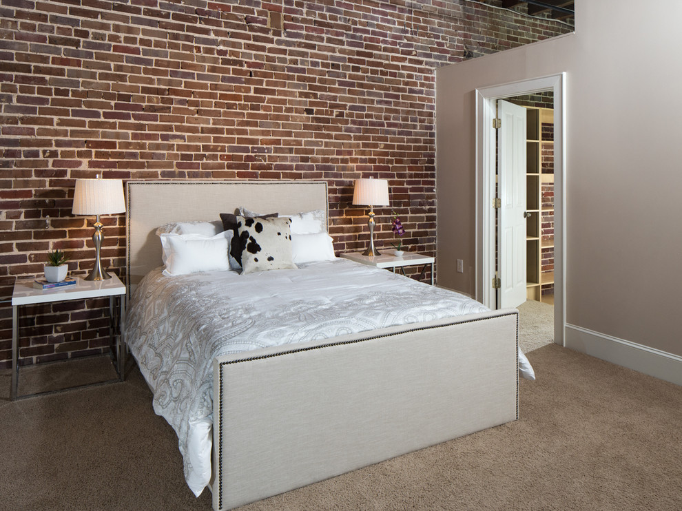 Photo of a mid-sized modern loft-style bedroom in Birmingham with beige walls, carpet and no fireplace.