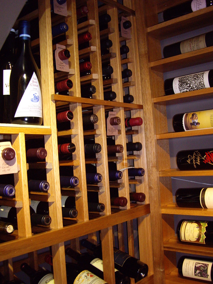 Photo of a mid-sized traditional wine cellar in Dallas with storage racks.
