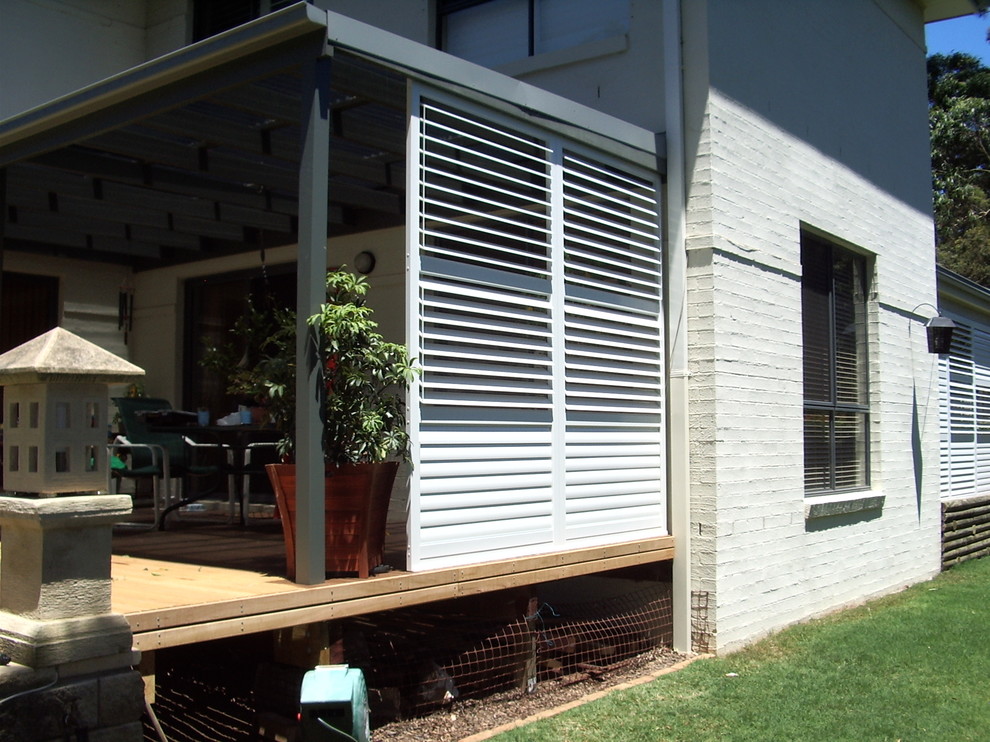 Photo of a mid-sized modern backyard verandah in Melbourne with decking.