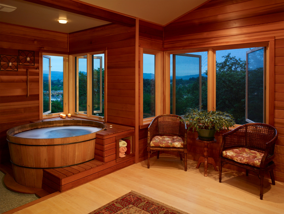 Design ideas for a traditional bathroom in Other with light hardwood floors and a hot tub.