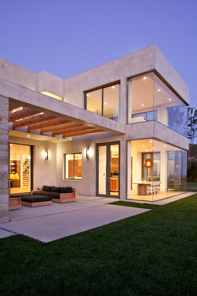 Inspiration for a large beach style two-storey concrete grey house exterior in Los Angeles with a flat roof.
