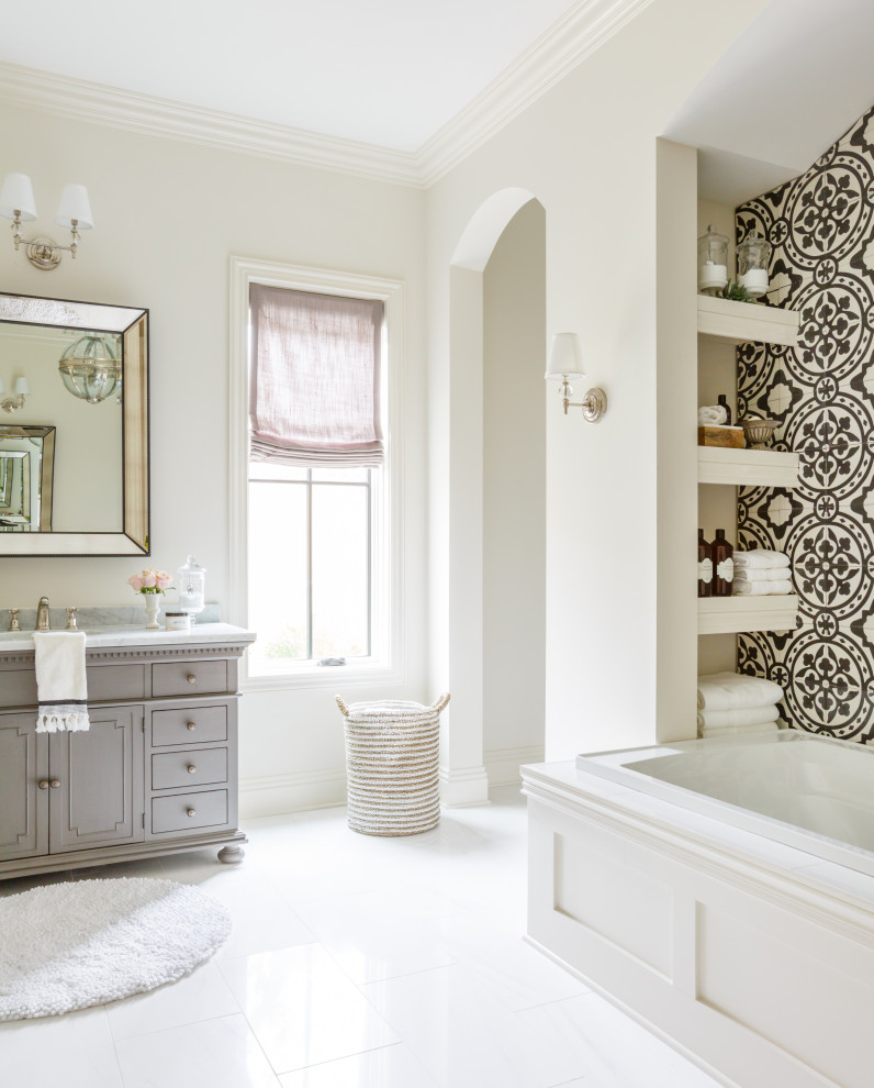 Inspiration for a transitional master bathroom in Jacksonville with recessed-panel cabinets, grey cabinets, a drop-in tub, black and white tile, white tile, an undermount sink, marble benchtops, white floor, grey benchtops, a single vanity and a built-in vanity.