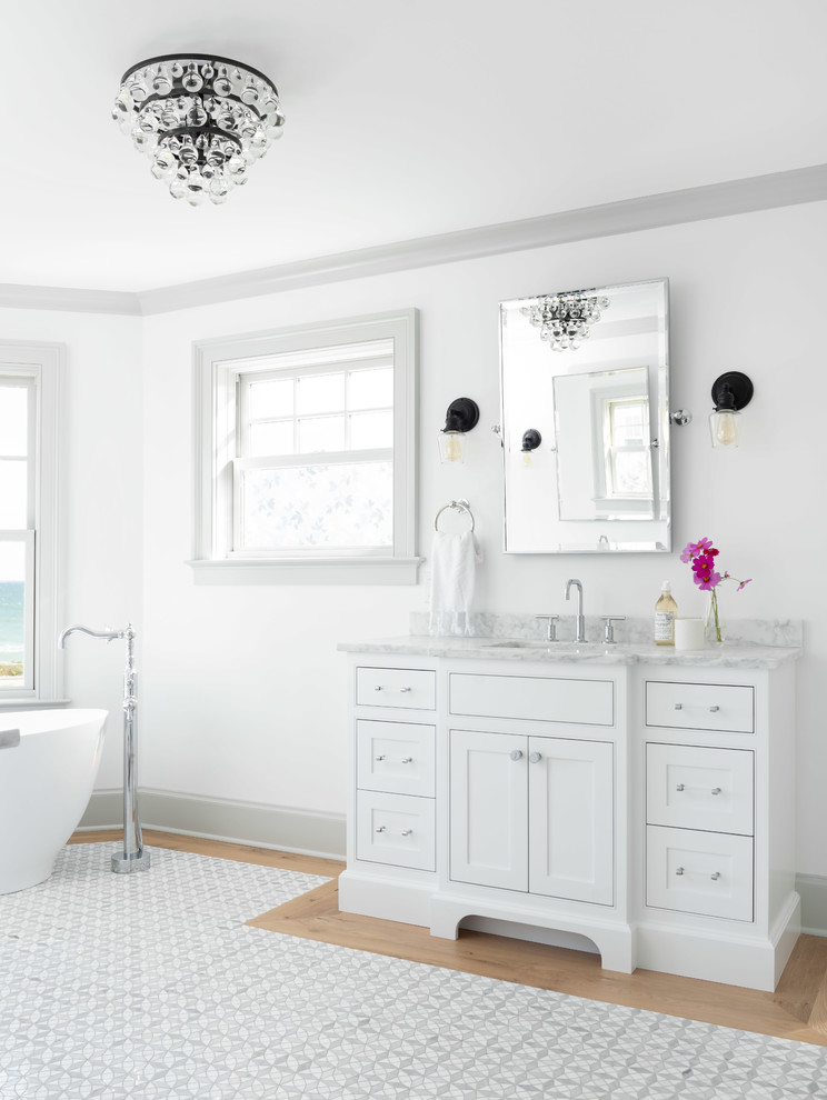 Example of a large transitional master marble floor freestanding bathtub design
