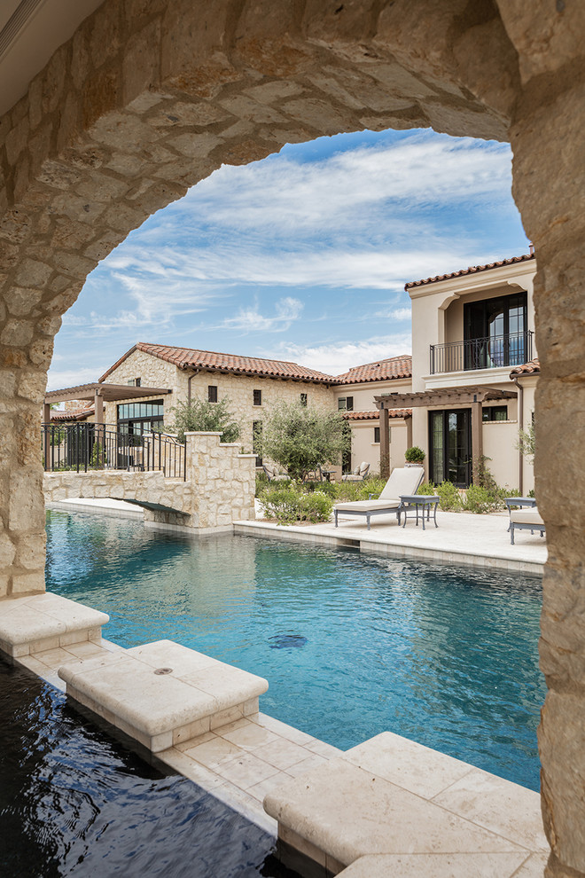 Photo of a large mediterranean courtyard rectangular lap pool in Phoenix with a hot tub.