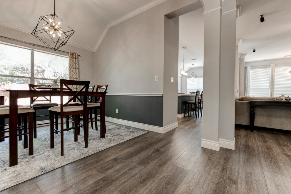 Design ideas for a mid-sized transitional open plan dining in Austin with grey walls, vinyl floors, brown floor, vaulted and decorative wall panelling.