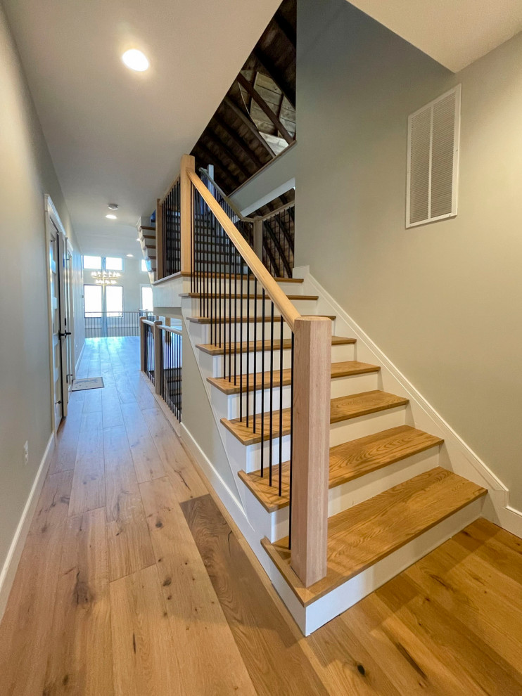 Design ideas for an expansive transitional wood straight staircase in DC Metro with wood risers and mixed railing.