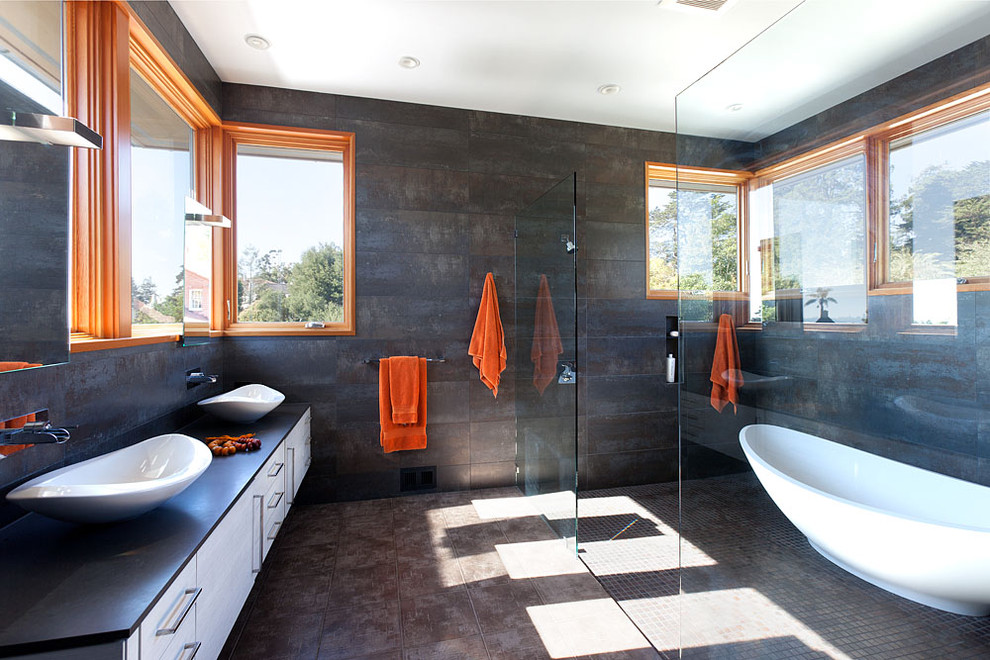 Design ideas for a large contemporary master bathroom in San Francisco with a freestanding tub, a vessel sink, flat-panel cabinets, white cabinets, an alcove shower, black walls, ceramic floors, brown floor, an open shower and black benchtops.