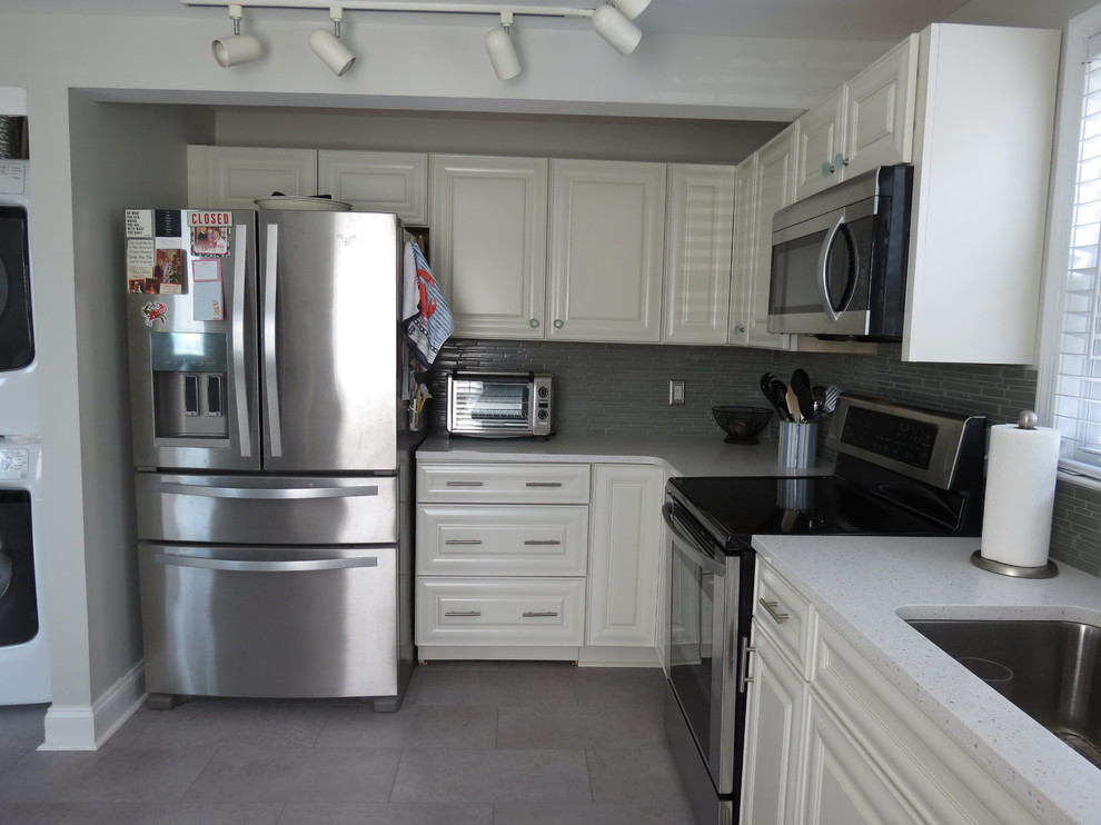 Mid-sized transitional l-shaped purple floor eat-in kitchen photo with an undermount sink, raised-panel cabinets, white cabinets, quartz countertops, gray backsplash, glass tile backsplash, stainless steel appliances, no island and white countertops