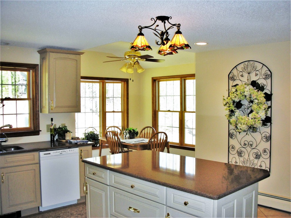 Eat-in kitchen - large u-shaped ceramic tile and beige floor eat-in kitchen idea with a double-bowl sink, raised-panel cabinets, beige cabinets, soapstone countertops, black backsplash, stainless steel appliances and an island
