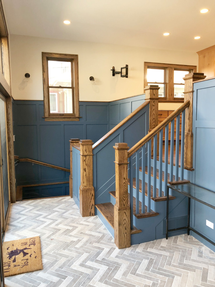 Design ideas for a mid-sized arts and crafts foyer in Chicago with blue walls, ceramic floors, a single front door and grey floor.