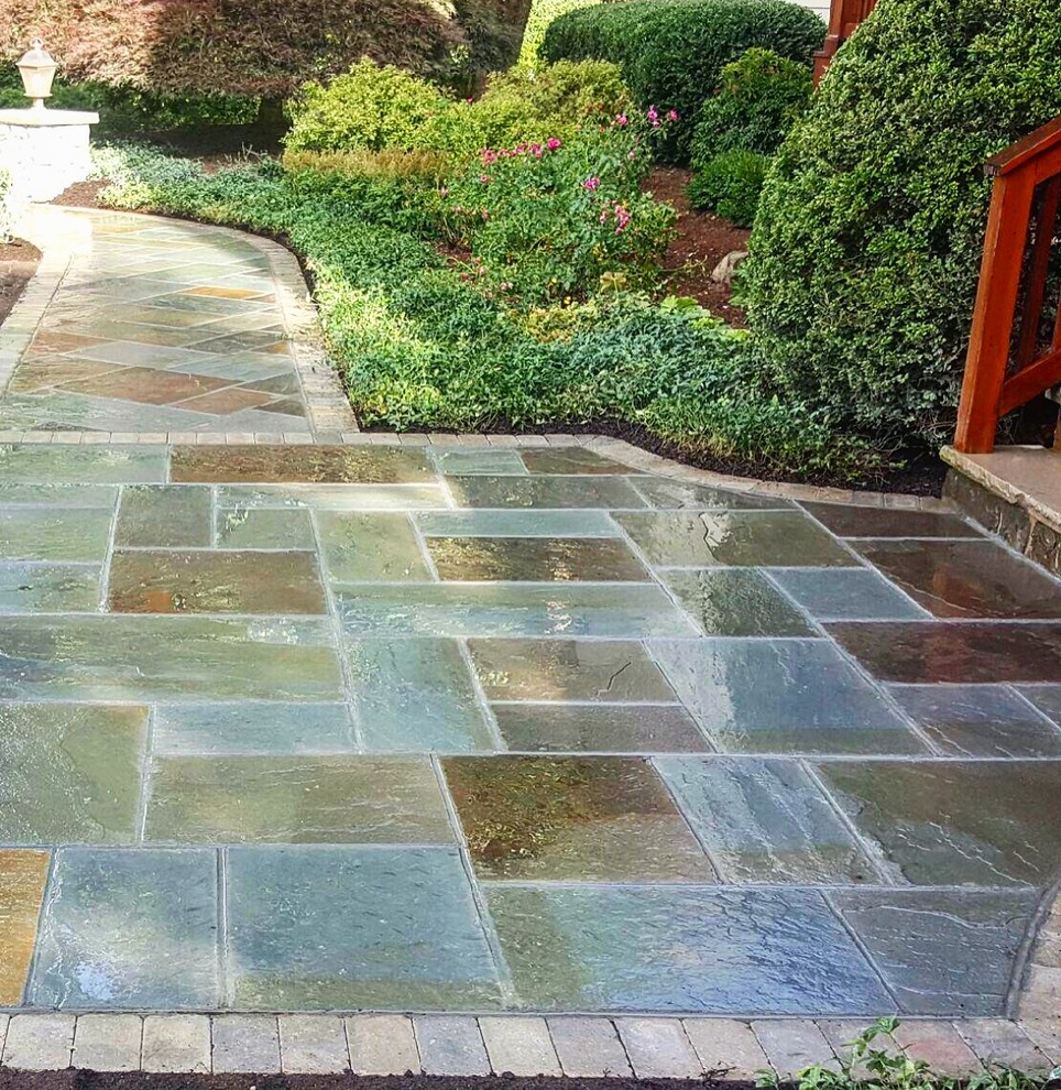 This is an example of a mid-sized country backyard garden in New York with a fire feature and natural stone pavers.